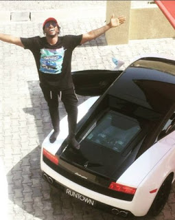 Runtown's beside his brand new car