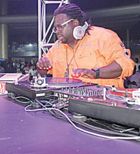 DJ Humility disck jockeying on stage