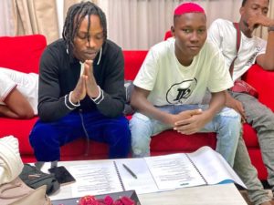 Naira Marley signing zinoleesky photo